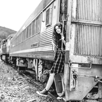 Young woman getting off freight train